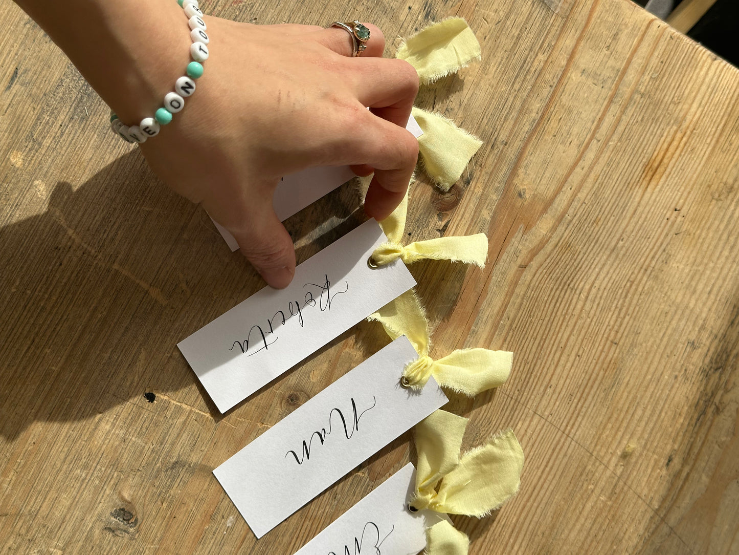 BUTTER Linen Calligraphy Place Name Card | White Calligraphy Wedding Place Name Card | Gold or Silver Eyelet
