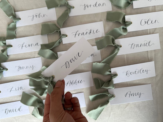 SAGE GREEN Satin Ribbon Calligraphy Place Name Card | White Calligraphy Wedding Place Name Card | Gold or Silver Eyelet