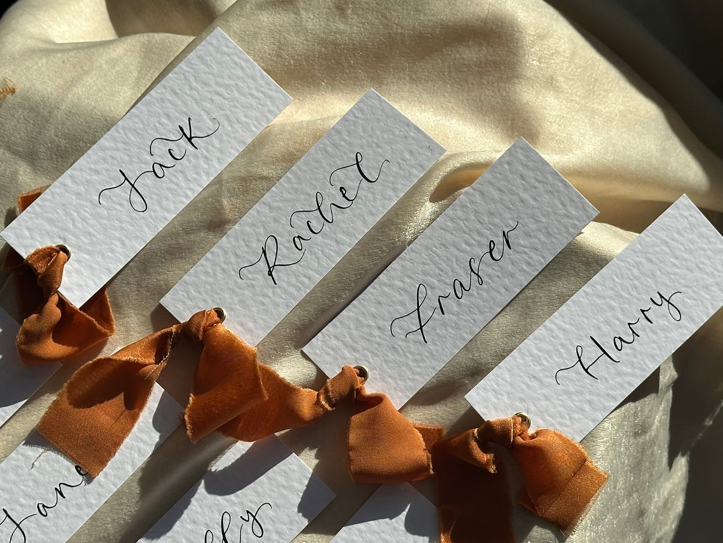 HAMMERED White + OCHRE Chiffon Ribbon Calligraphy Place Name Card | Calligraphy Wedding Place Name Card | Gold or Silver Eyelet Place Card