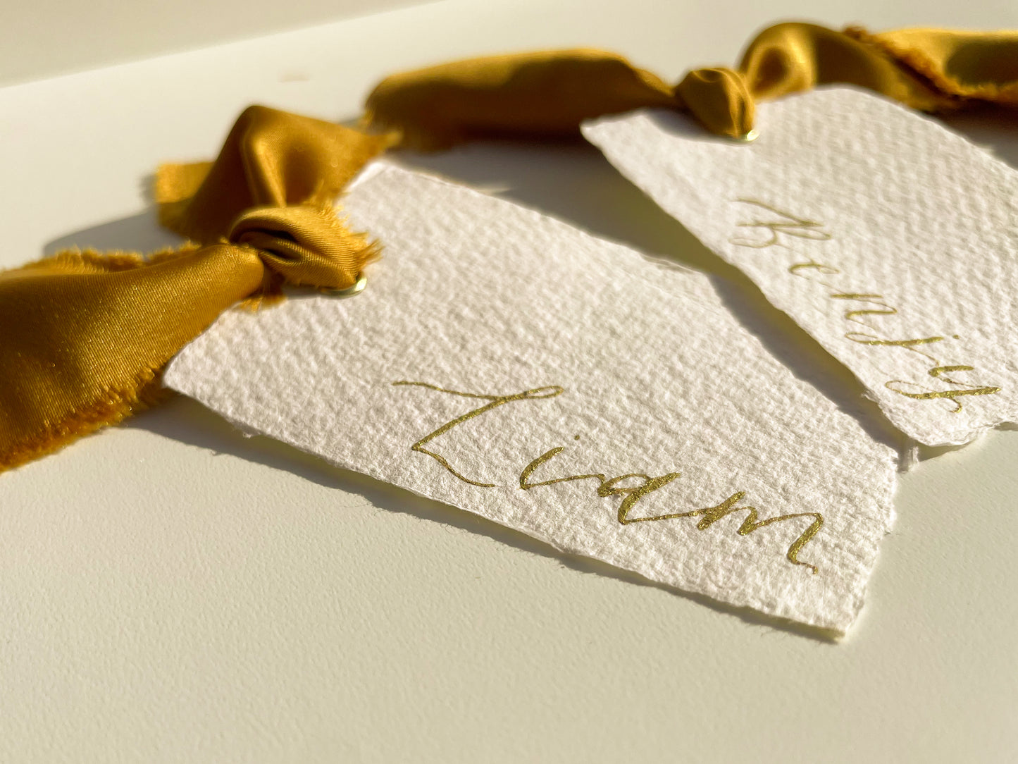 HANDMADE PAPER Ribbon Calligraphy Place Name Card | White Calligraphy Wedding Place Name Card | Gold or Silver Eyelet Place Card