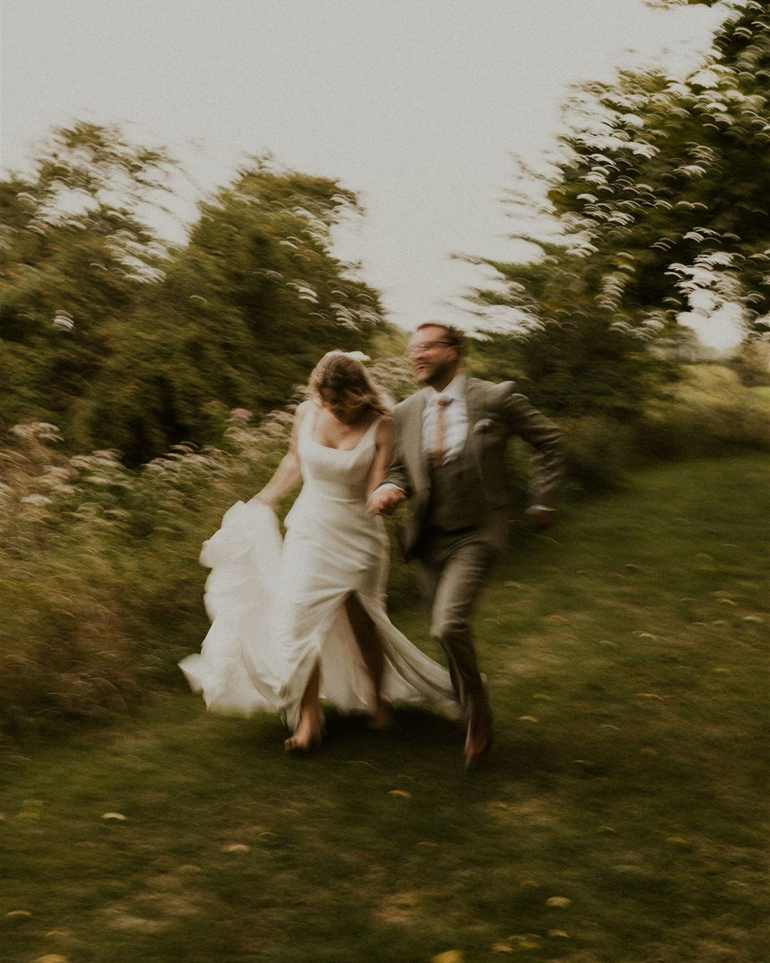 a barefoot bride and her new husband in the gardens of @grosvenorpulfordhotel green and white wedding 2026