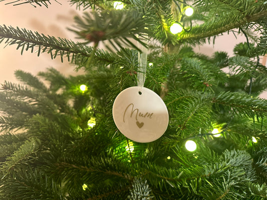 Decorative ornament with 'Mum' on a Christmas tree