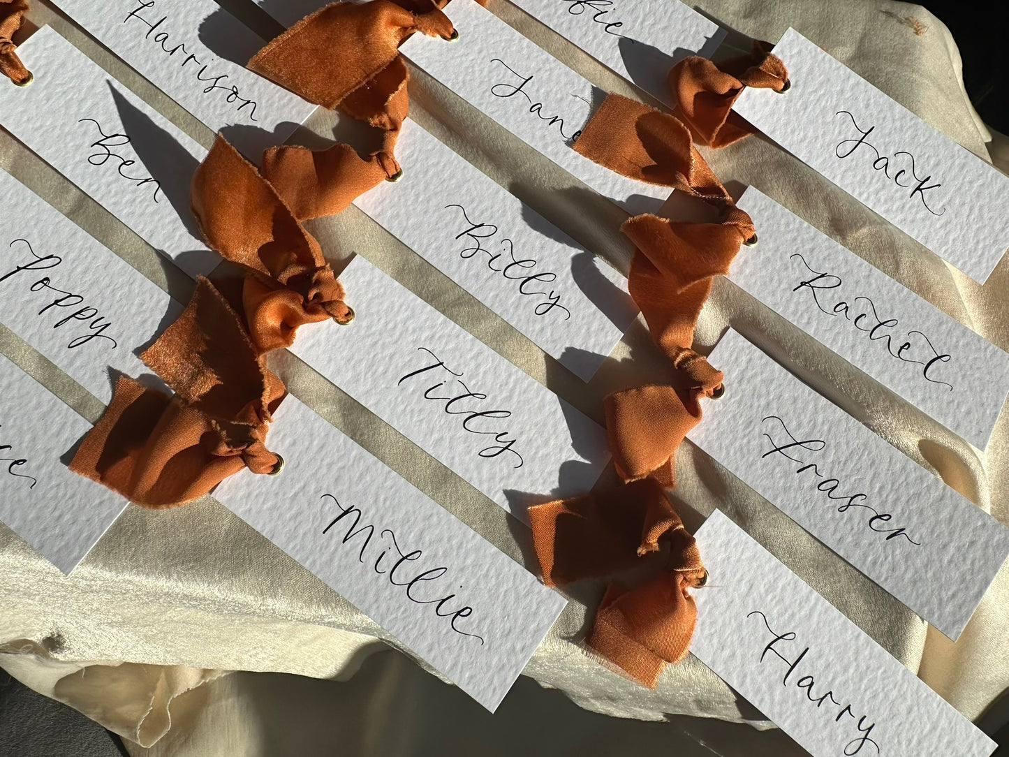 HAMMERED White + OCHRE Chiffon Ribbon Calligraphy Place Name Card | Calligraphy Wedding Place Name Card | Gold or Silver Eyelet Place Card