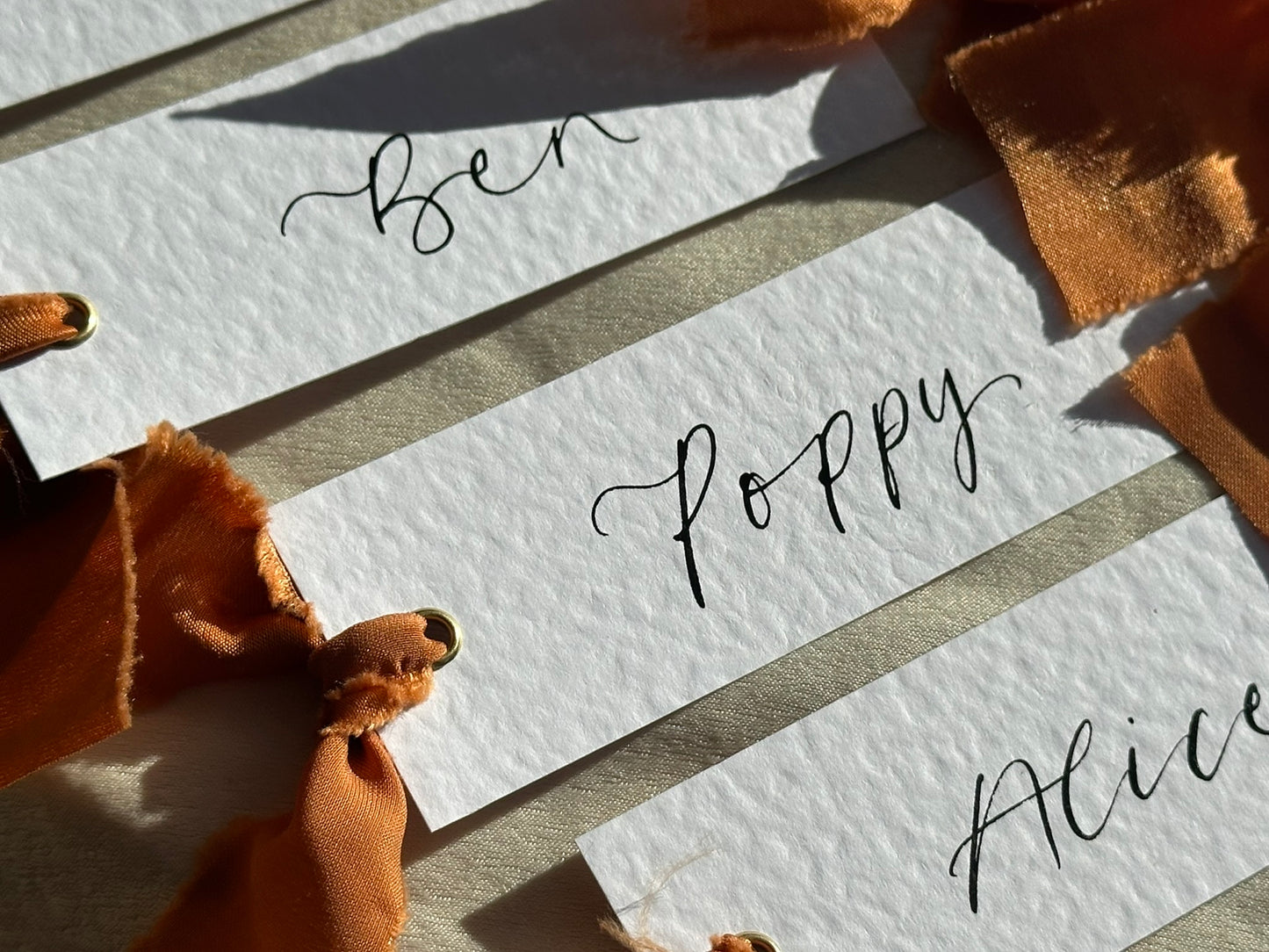 HAMMERED White + OCHRE Chiffon Ribbon Calligraphy Place Name Card | Calligraphy Wedding Place Name Card | Gold or Silver Eyelet Place Card