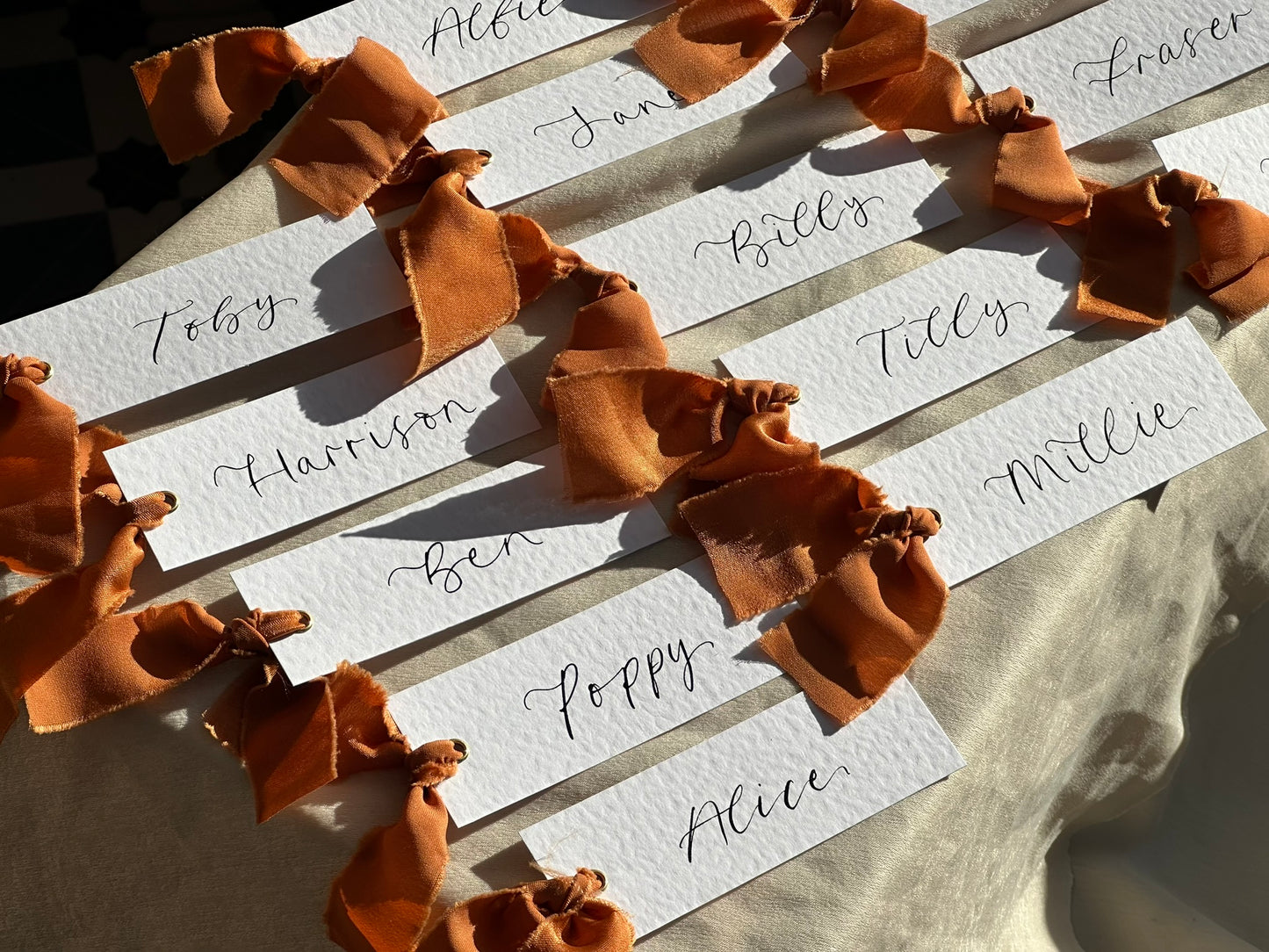 HAMMERED White + OCHRE Chiffon Ribbon Calligraphy Place Name Card | Calligraphy Wedding Place Name Card | Gold or Silver Eyelet Place Card