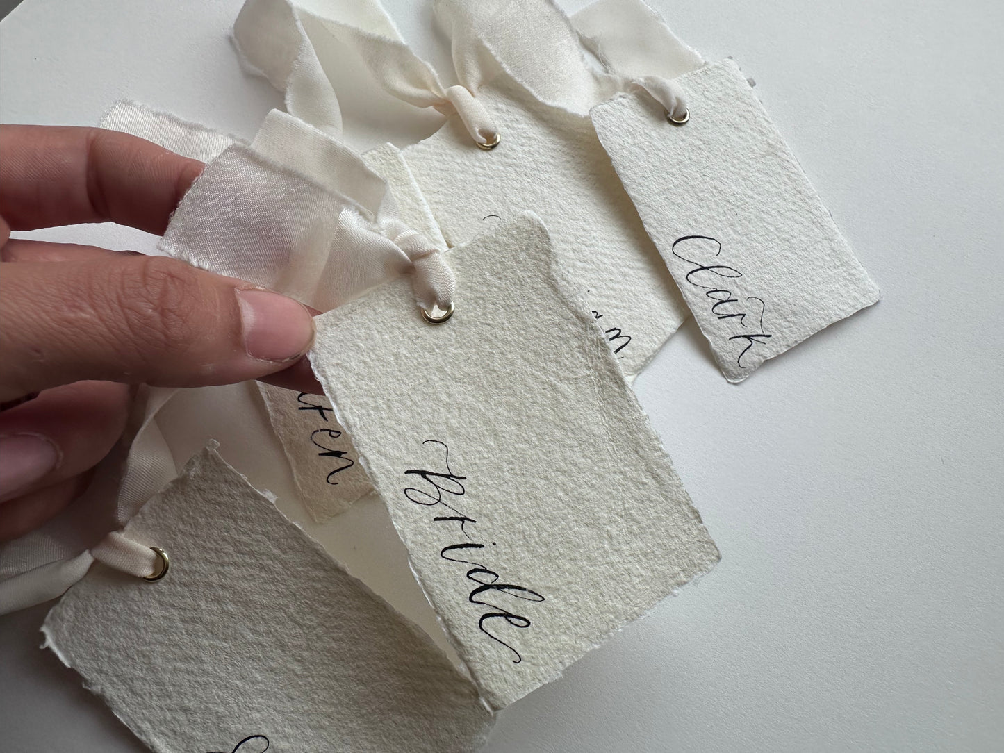 HANDMADE PAPER Ribbon Calligraphy Place Name Card | White Calligraphy Wedding Place Name Card | Gold or Silver Eyelet Place Card