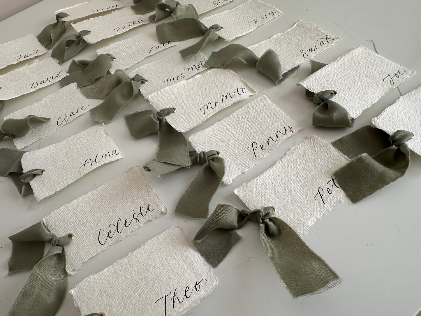 HANDMADE PAPER Ribbon Calligraphy Place Name Card | White Calligraphy Wedding Place Name Card | Gold or Silver Eyelet Place Card