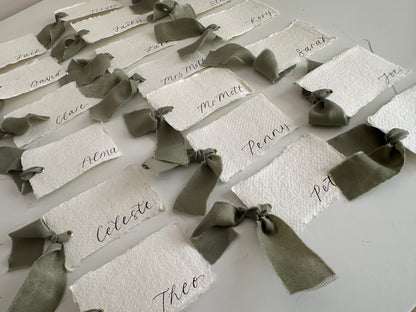 HANDMADE PAPER Ribbon Calligraphy Place Name Card | White Calligraphy Wedding Place Name Card | Gold or Silver Eyelet Place Card