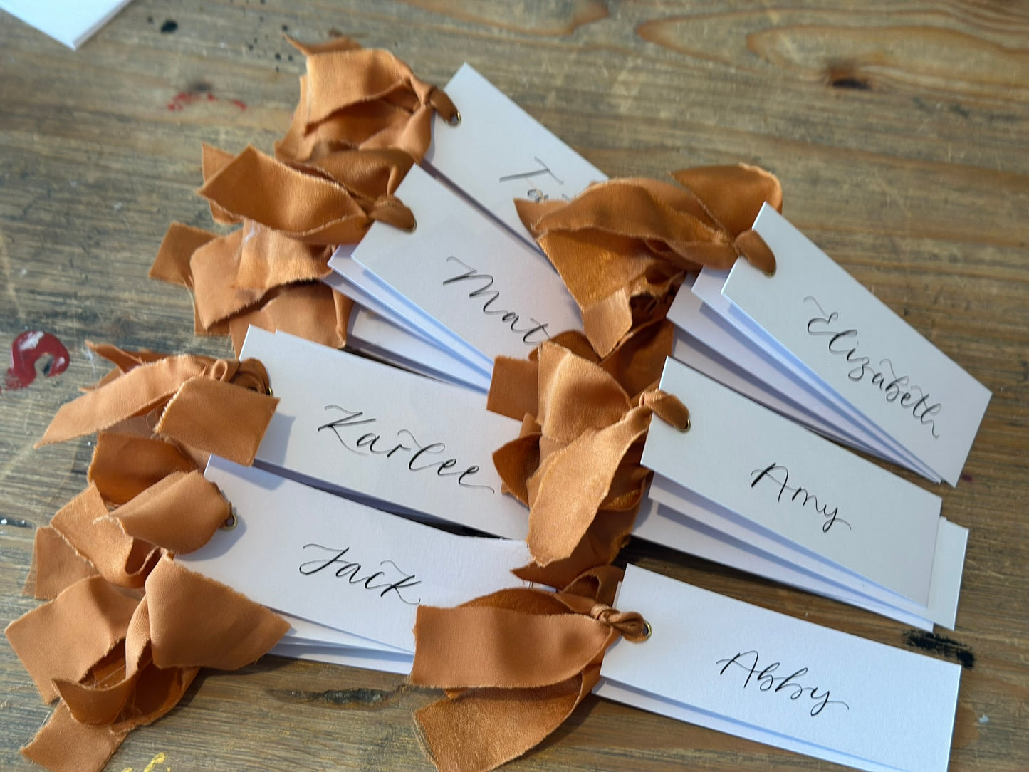 OCHRE Chiffon Ribbon Calligraphy Place Name Card | White Calligraphy Wedding Place Name Card | Gold or Silver Eyelet