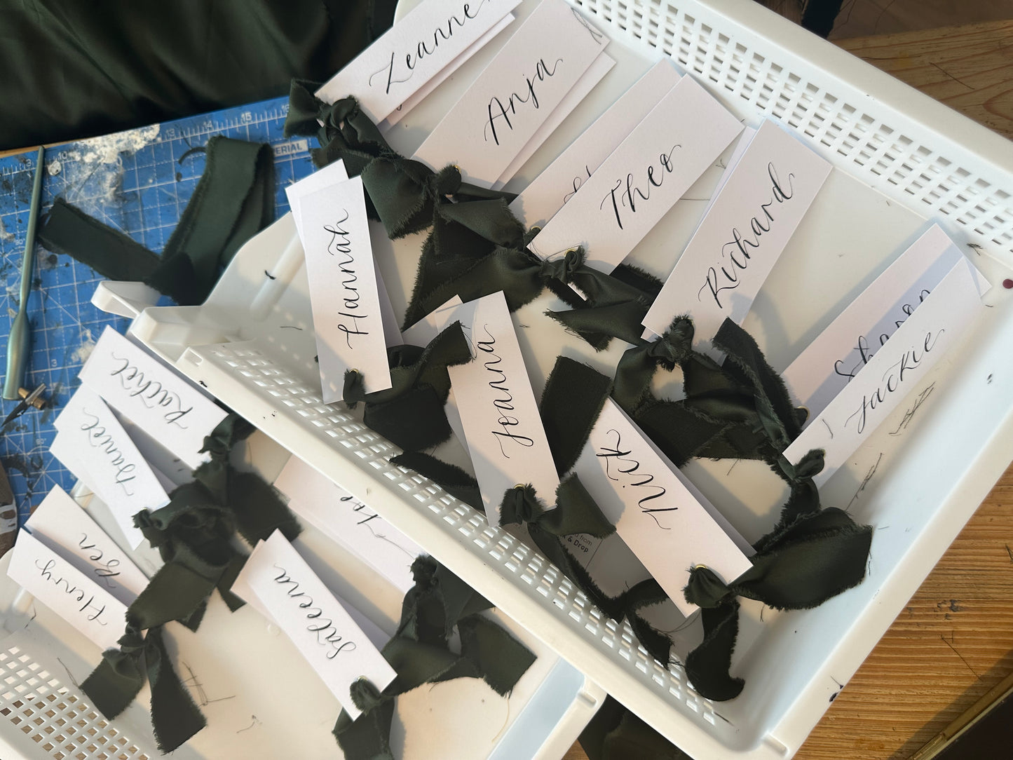 White Forest Satin Wedding Place Cards with Ribbon | Dark Green Calligraphy Place Cards