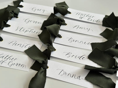 White Forest Satin Wedding Place Cards with Ribbon | Dark Green Calligraphy Place Cards