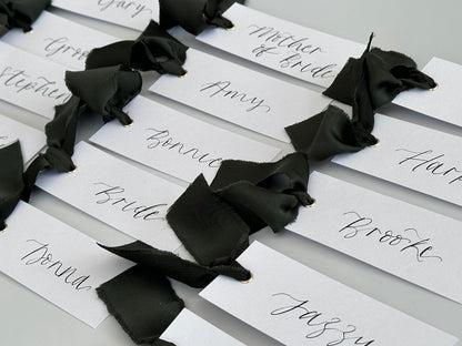 White Forest Satin Wedding Place Cards with Ribbon | Dark Green Calligraphy Place Cards