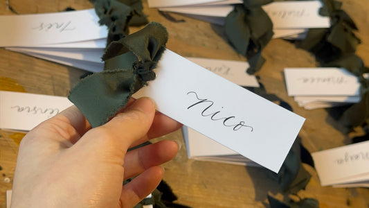 White Forest Satin Wedding Place Cards with Ribbon | Dark Green Calligraphy Place Cards