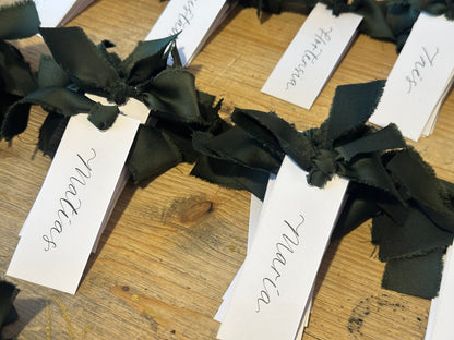 White Forest Satin Wedding Place Cards with Ribbon | Dark Green Calligraphy Place Cards