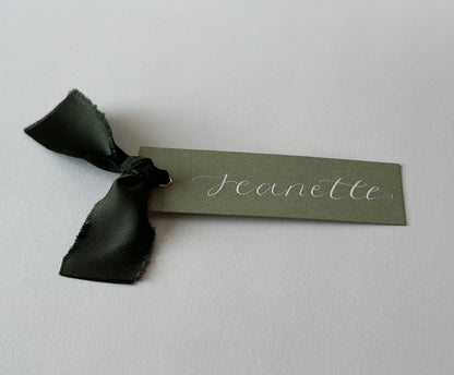 dark green wedding place card, rustic wedding decor, elegant escort cards, customizable place settings, eco-friendly wedding details, garden wedding theme, personalized card holders, handwritten calligraphy, vintage wedding styling, sustainable wedding accessories