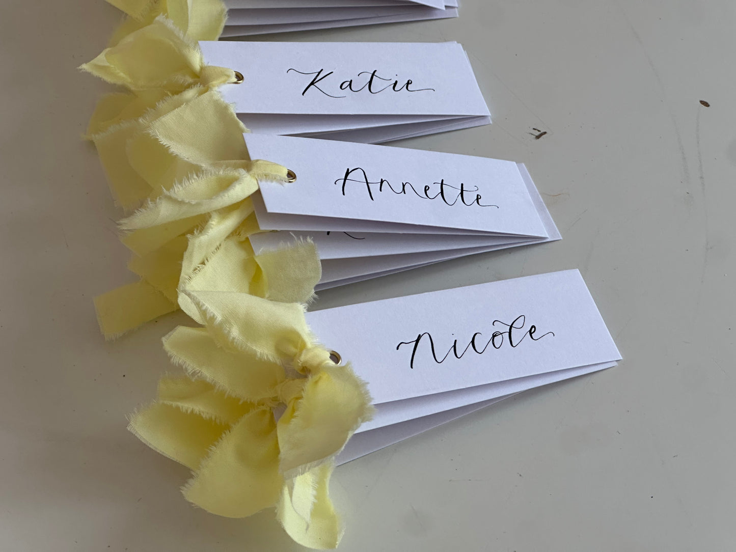 BUTTER Ribbon Calligraphy Place Name Card | White Calligraphy Wedding Place Name Card | Gold or Silver Eyelet