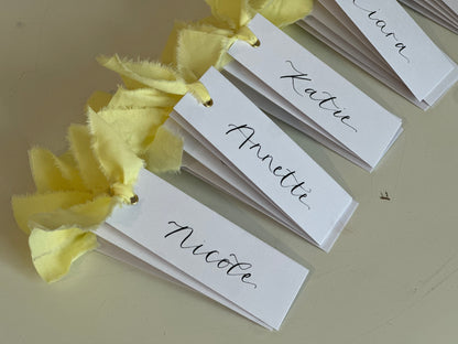 BUTTER Ribbon Calligraphy Place Name Card | White Calligraphy Wedding Place Name Card | Gold or Silver Eyelet