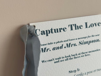 Personalised printed wedding sign on A5 hammered white card with dusky blue chiffon ribbon and silver eyelet