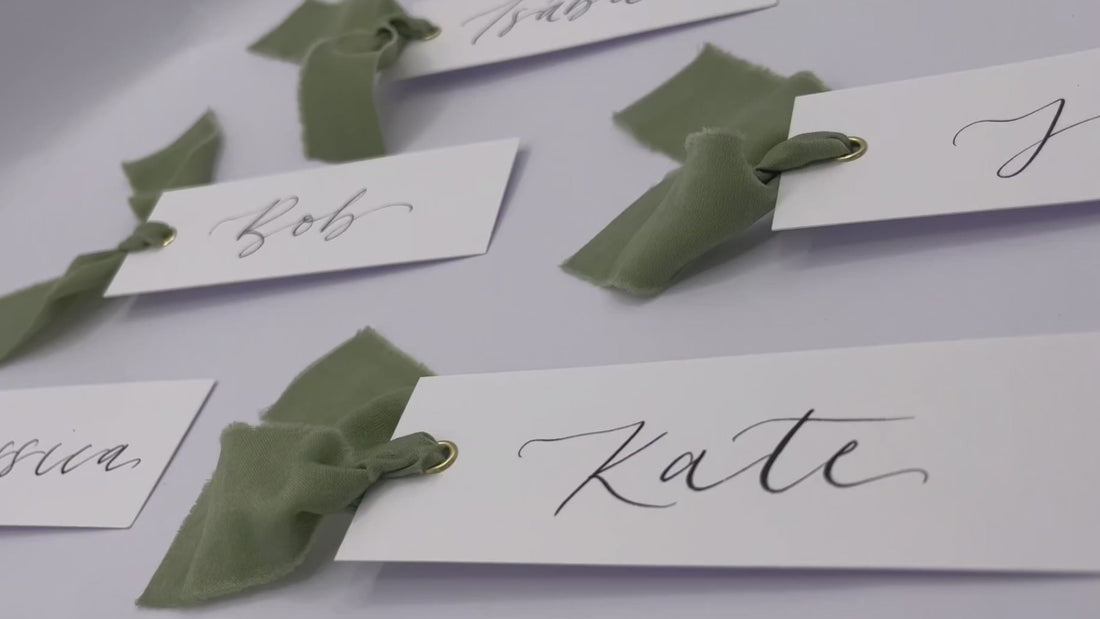 Calligraphy place cards with eucalyptus dark green ribbon and gold eyelets, wedding place card, wedding place name