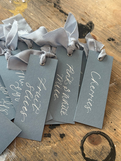 Handwritten sweet buffet labels with dusky blue chiffon ribbon for wedding dessert tables