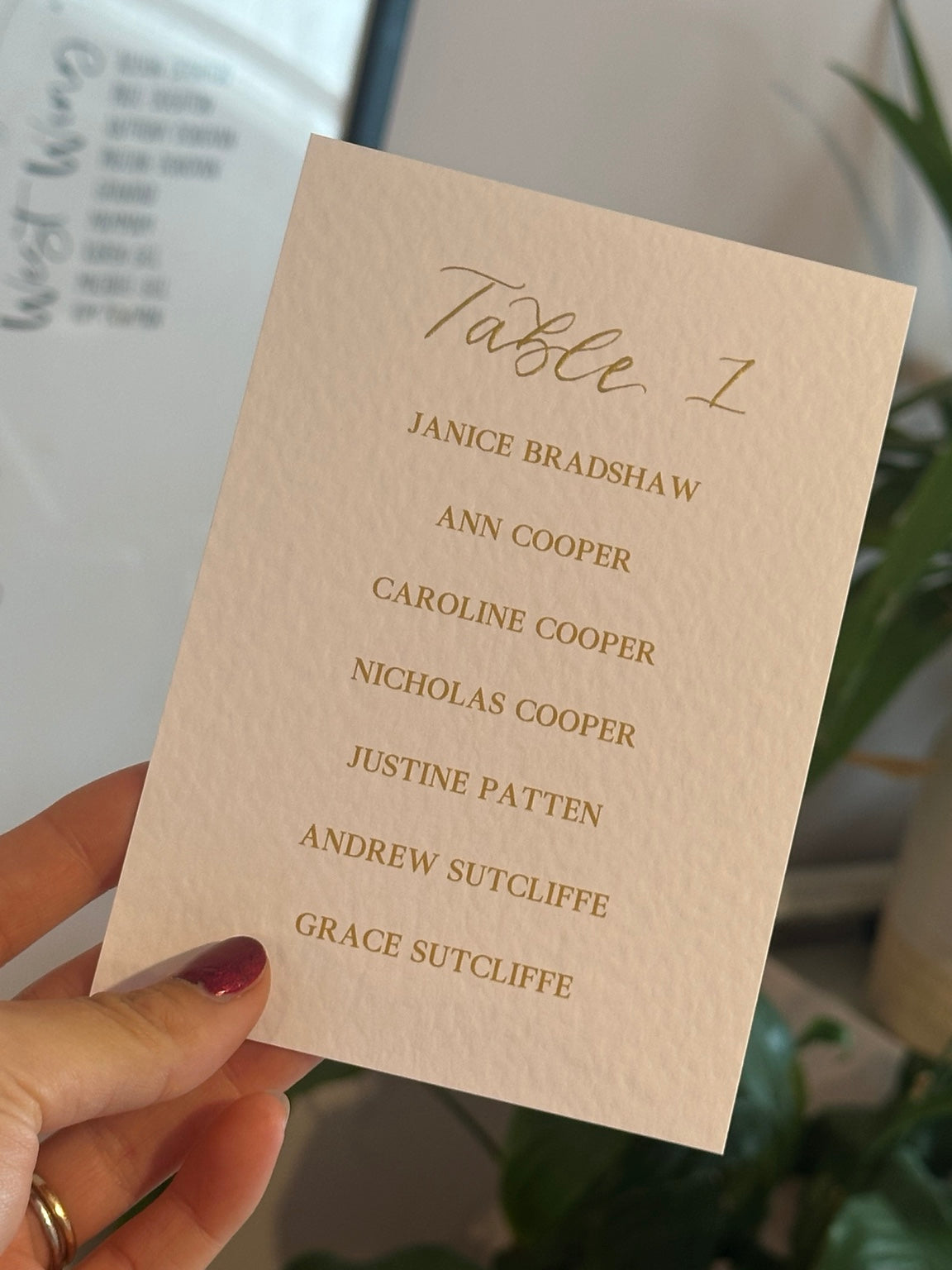 Close-up of a personalised table plan card in warm-toned card