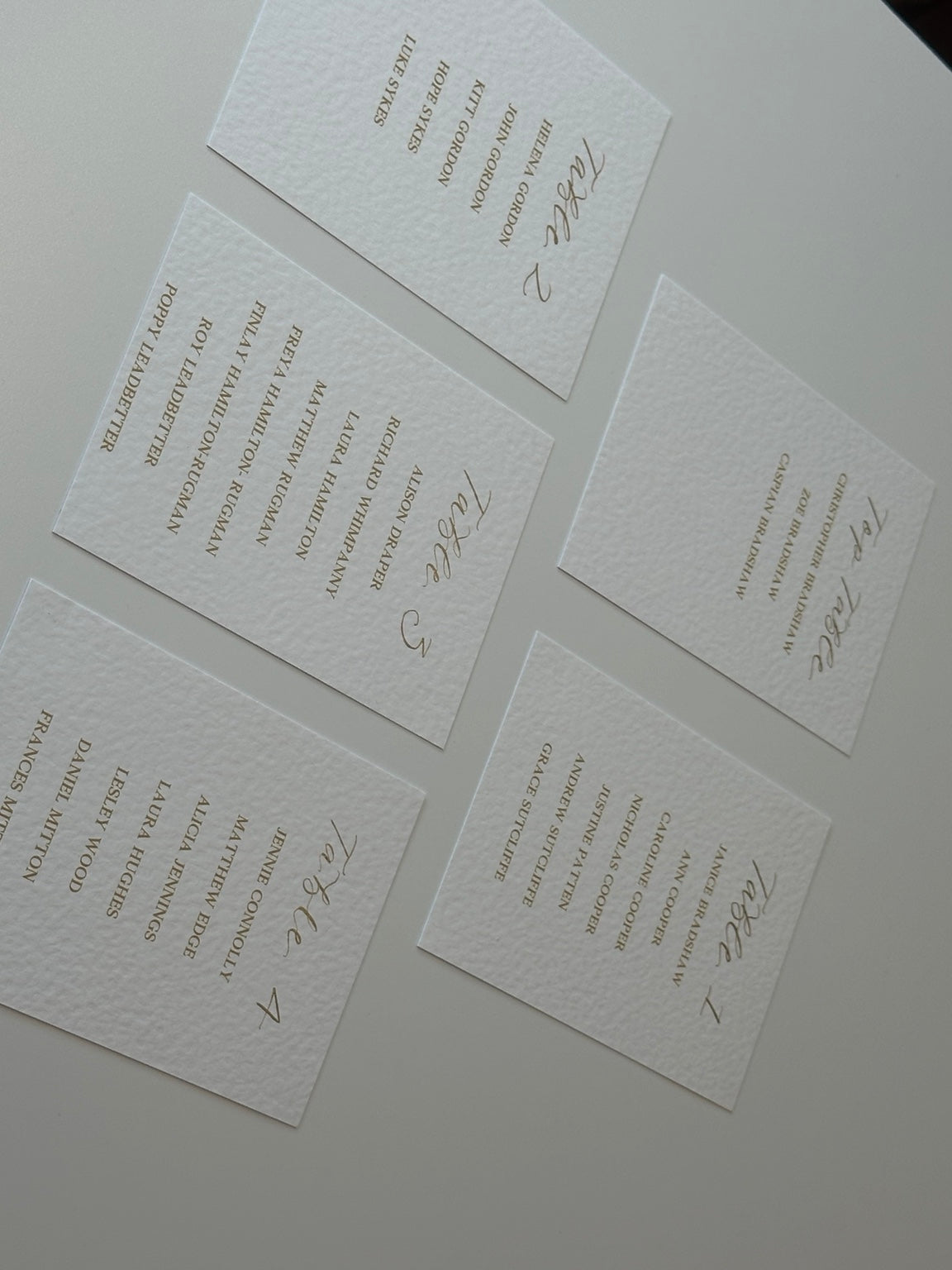 Flat lay of personalised wedding table plan cards