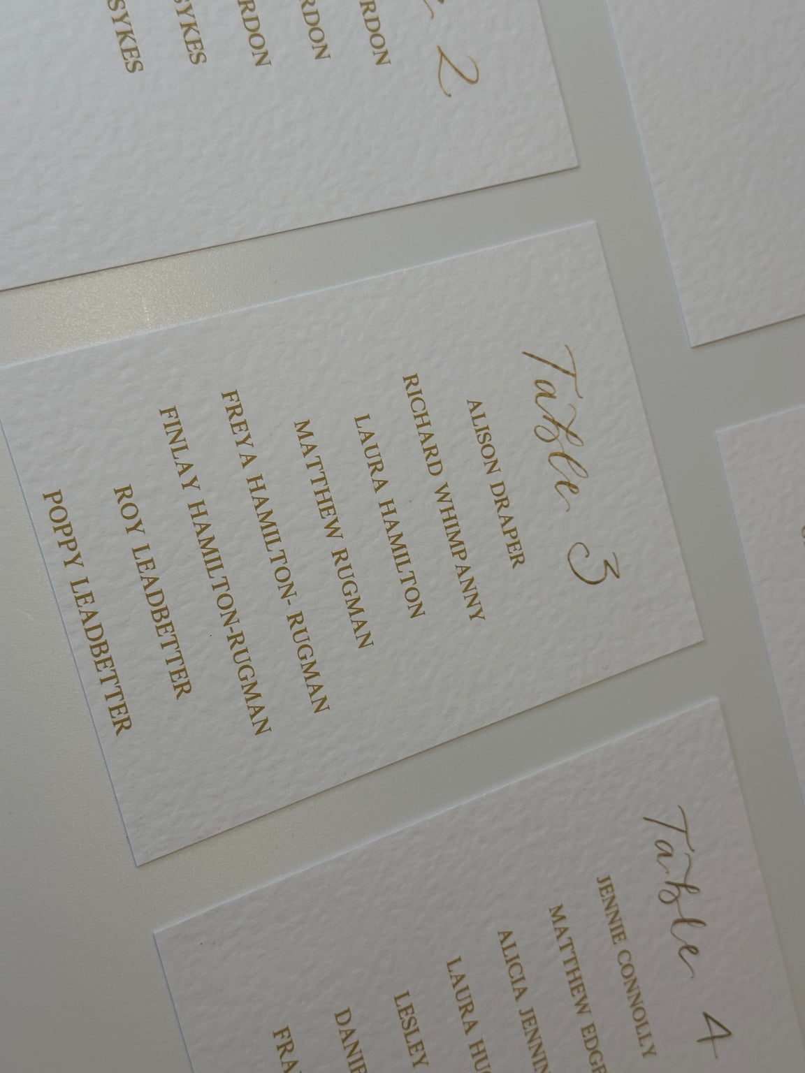 Detail of personalised table plan cards on textured card