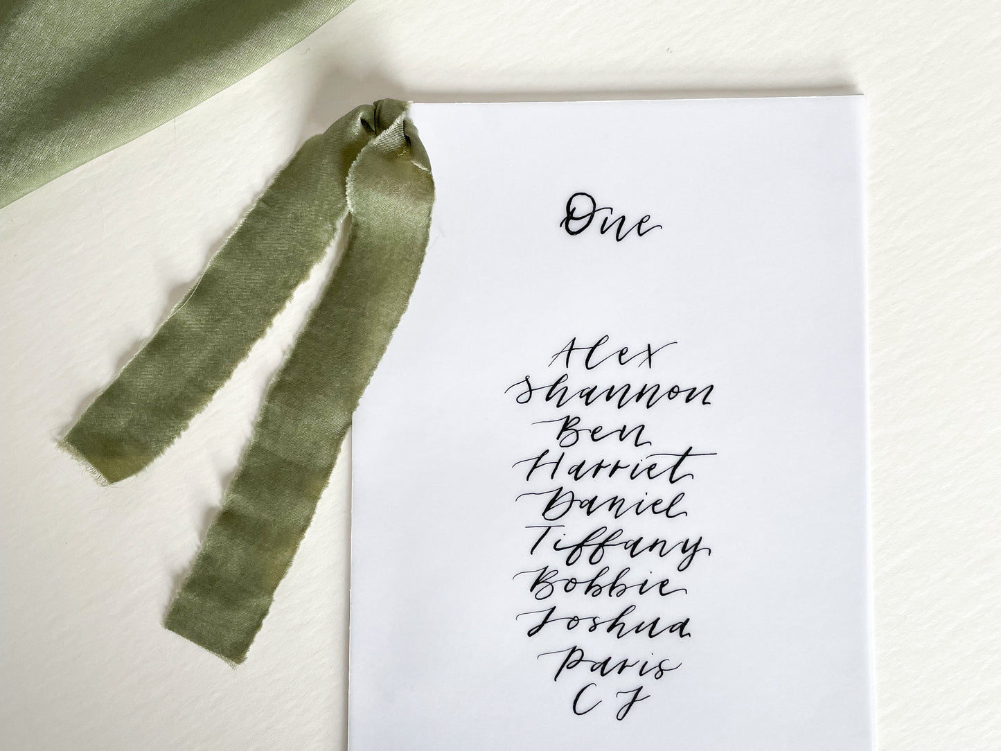 vellum Table plan card with chiffon ribbon , modern calligraphy, calligraphy table plan, vellum table plan, handwritten table plan card, modern table plan, traditional table plan, modern wedding decor, chiffon table plan, ribbon table plan, eucalyptus, sage, green, forest green, 