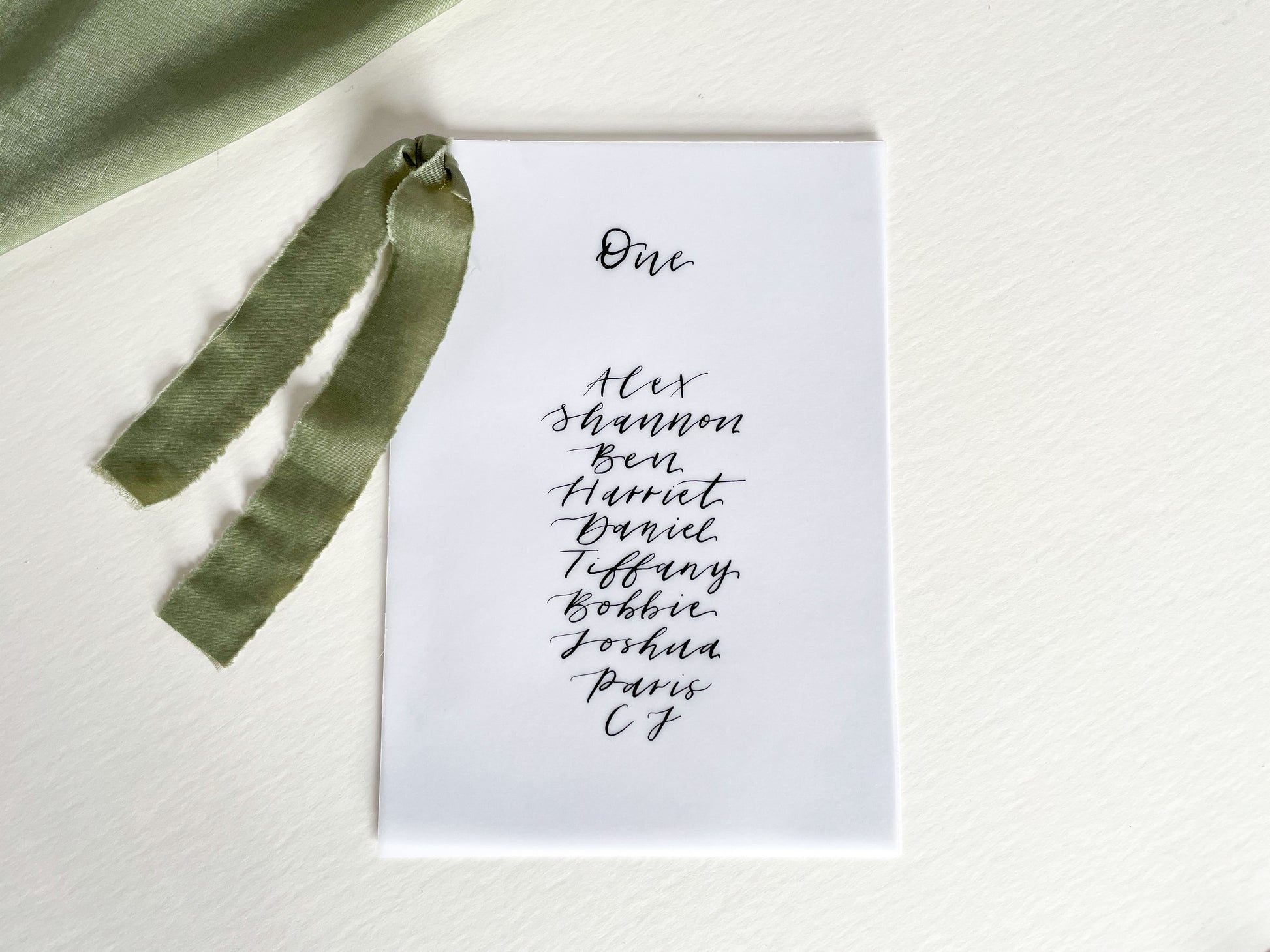 vellum Table plan card with chiffon ribbon , modern calligraphy, calligraphy table plan, vellum table plan, handwritten table plan card, modern table plan, traditional table plan, modern wedding decor, chiffon table plan, ribbon table plan, eucalyptus, sage, green, forest green, 